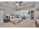 Spacious main bedroom featuring a trey ceiling, sitting area, fireplace, and natural light at 2475 Gants Hill Pl, Cumming, GA 30041