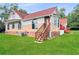 House exterior showcasing a red roof, brick accents, and stairs leading to an entrance at 300 Jonesboro Rd, Mcdonough, GA 30253