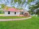 Exterior view of a charming house with a red roof and brick accents at 300 Jonesboro Rd, Mcdonough, GA 30253