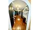 Long hallway with hardwood floors and multiple doors leading to other rooms at 300 Jonesboro Rd, Mcdonough, GA 30253