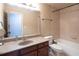 Bathroom featuring granite countertops, dark wood cabinet and combined shower/tub at 4335 Silent Path, Cumming, GA 30028