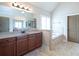 Bright bathroom with granite countertops, wooden cabinets, and a separate tub at 4335 Silent Path, Cumming, GA 30028