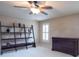 Bedroom with dark wood furniture, a display case and a ceiling fan with light at 4335 Silent Path, Cumming, GA 30028