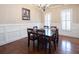 Light-filled dining room featuring hardwood floors, wainscoting and white plantation shutters at 4335 Silent Path, Cumming, GA 30028