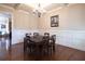 Formal dining room features hardwood floors, wainscoting, and a chandelier at 4335 Silent Path, Cumming, GA 30028