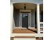 Dark gray front door with sidelights and a welcoming porch at 4335 Silent Path, Cumming, GA 30028
