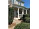 Covered front porch with white columns and gray exterior at 4335 Silent Path, Cumming, GA 30028