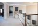 Hallway with neutral carpet, white railings and grey walls at 4335 Silent Path, Cumming, GA 30028