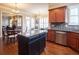 Well-lit kitchen with a large island and stainless steel appliances open to living spaces at 4335 Silent Path, Cumming, GA 30028