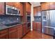 Close up of the kitchen's stainless steel appliances, granite countertops, and wooden cabinets at 4335 Silent Path, Cumming, GA 30028