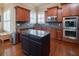 Gourmet kitchen featuring an island with granite countertops, and stainless steel appliances at 4335 Silent Path, Cumming, GA 30028