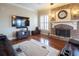Inviting living room features stone fireplace, hardwood floors, and comfortable seating for relaxation at 4335 Silent Path, Cumming, GA 30028