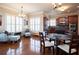 Bright living area with hardwood floors, shuttered windows, and an adjacent kitchen for seamless entertaining at 4335 Silent Path, Cumming, GA 30028