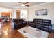 Spacious living room featuring hardwood floors, comfortable seating, and an open layout to adjacent spaces at 4335 Silent Path, Cumming, GA 30028