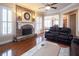 Comfortable living room with stone fireplace, hardwood floors, and ample natural light at 4335 Silent Path, Cumming, GA 30028
