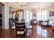 Open concept living area with a stacked stone fireplace and dining area with seating at 4335 Silent Path, Cumming, GA 30028