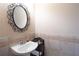 Stylish powder room with elegant mirror, tiled wainscoting, and a modern sink at 4335 Silent Path, Cumming, GA 30028
