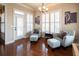 Cozy sitting area bathed in natural light with plantation shutters and two armchairs at 4335 Silent Path, Cumming, GA 30028