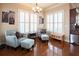 Inviting sitting room features shuttered windows, hardwood floors, and cozy seating with natural light at 4335 Silent Path, Cumming, GA 30028