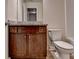 Bathroom with dark wood vanity and a white toilet at 5831 Taka Ln, Lithonia, GA 30038