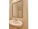 Bathroom featuring a pedestal sink and framed mirror at 5831 Taka Ln, Lithonia, GA 30038