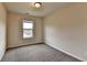 Bedroom features neutral walls, soft carpet, and natural light at 5831 Taka Ln, Lithonia, GA 30038