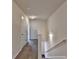 Hallway with carpet, white walls, stairs, and a white door at 5831 Taka Ln, Lithonia, GA 30038