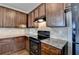 Updated kitchen with granite counters, wooden cabinets, and modern black oven at 5831 Taka Ln, Lithonia, GA 30038