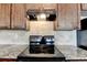 Updated kitchen featuring granite countertops, stone backsplash, and a modern black oven at 5831 Taka Ln, Lithonia, GA 30038
