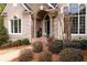 Close-up of a beautiful brick porch with a dark blue door and tasteful landscaping at 201 Russell Ct, Canton, GA 30115