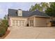 Attached two-car garage featuring glass doors, a long driveway, and beautiful yard at 201 Russell Ct, Canton, GA 30115