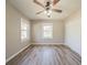 Bright and airy bedroom featuring laminate floors, two windows, and a ceiling fan at 2103 Mcafee Rd, Decatur, GA 30032