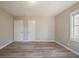 This bedroom has neutral paint, wood-look flooring, and ample closet space at 2103 Mcafee Rd, Decatur, GA 30032