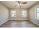 Well-lit bedroom featuring sleek laminate floors, two windows, and a ceiling fan at 2103 Mcafee Rd, Decatur, GA 30032