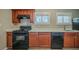 Well-lit kitchen featuring modern black appliances, bright countertops, and wooden cabinets at 2103 Mcafee Rd, Decatur, GA 30032