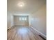 Bright, spacious living room with ample natural light and modern wood flooring at 2103 Mcafee Rd, Decatur, GA 30032