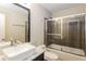 Updated bathroom featuring a sleek vanity, modern vessel sink, and tiled shower with glass door at 2229 Bigwood Trl, Atlanta, GA 30349