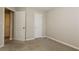 An additional bedroom includes carpet flooring and a white door offering closet space at 2229 Bigwood Trl, Atlanta, GA 30349