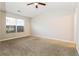 Bright, carpeted bedroom with a ceiling fan and a large window providing natural light at 2229 Bigwood Trl, Atlanta, GA 30349