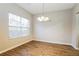 Dining area with wood floors, chandelier, and a large window providing natural light at 2229 Bigwood Trl, Atlanta, GA 30349