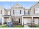 Charming townhome featuring a well-maintained lawn and a mix of vinyl siding and brick facade at 2229 Bigwood Trl, Atlanta, GA 30349