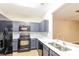 Modern kitchen featuring stainless steel appliances, gray cabinets and white countertops at 2229 Bigwood Trl, Atlanta, GA 30349