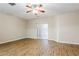Bright living room with wood floors, ceiling fan, and sliding door access to the exterior at 2229 Bigwood Trl, Atlanta, GA 30349