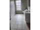 Bright bathroom with white cabinets, a toilet, light walls, and patterned tile floors at 3033 Semmes St, Atlanta, GA 30344
