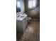 Bathroom with white vanity, mirror, toilet, and neutral tile flooring at 3033 Semmes St, Atlanta, GA 30344