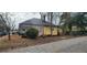 Street view of a yellow home with black roof, chimney and sparse landscaping at 3033 Semmes St, Atlanta, GA 30344