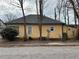 Side view of yellow home featuring classic architecture and multiple windows for ample natural light at 3033 Semmes St, Atlanta, GA 30344