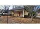 Charming yellow home featuring a covered front porch and simple landscaping at 3033 Semmes St, Atlanta, GA 30344