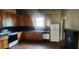 Eat-in kitchen featuring wood cabinets and black countertops, with wood flooring at 3033 Semmes St, Atlanta, GA 30344