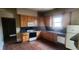 Traditional kitchen with wood cabinets, black countertops, and wood flooring at 3033 Semmes St, Atlanta, GA 30344